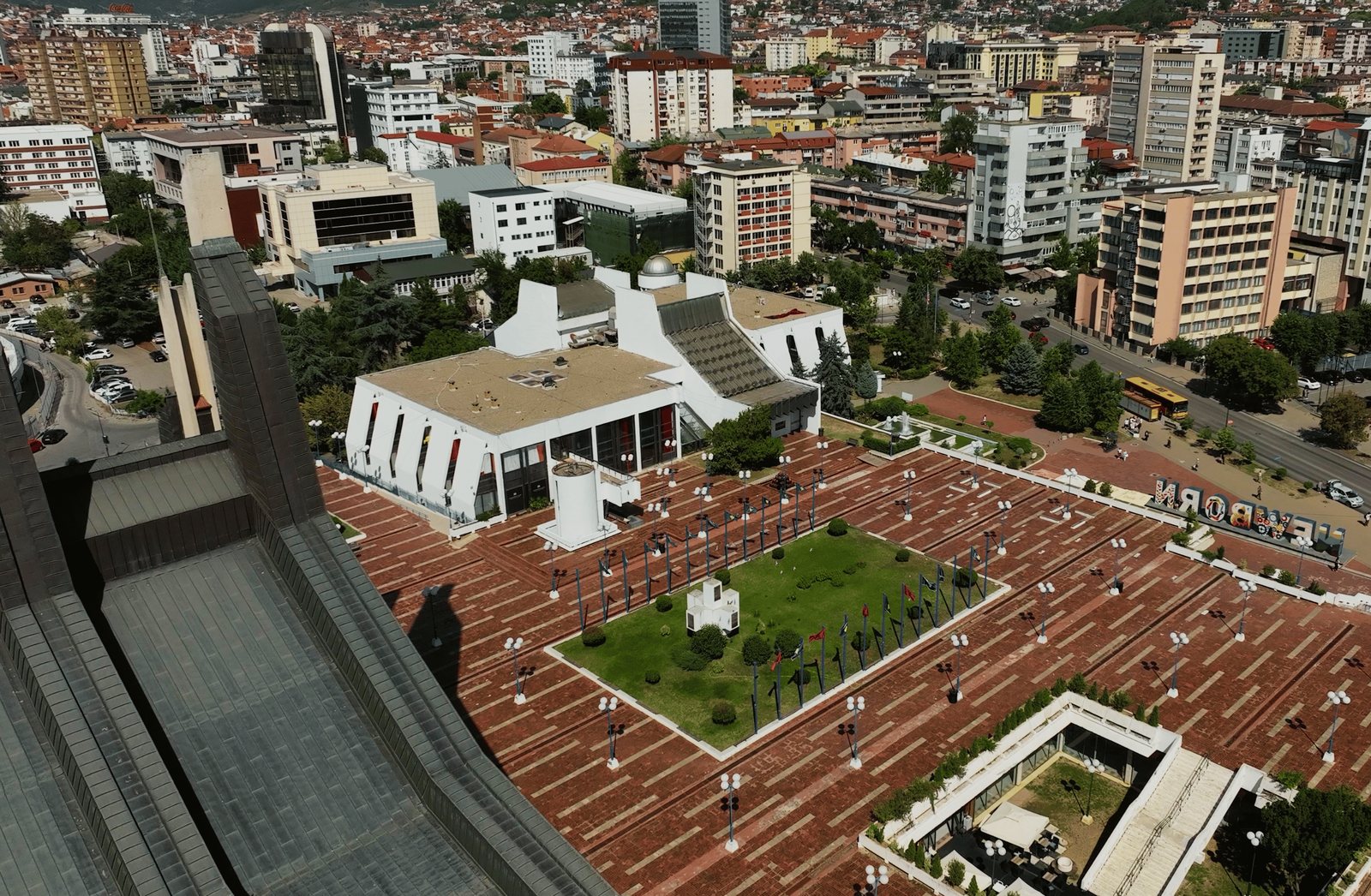 The Palace of Youth and Sports. Salla e Kuqe is the low white wing on the plateau.